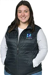 4imprint employee Kyrie wearing the Crossland Packable Puffer Vest